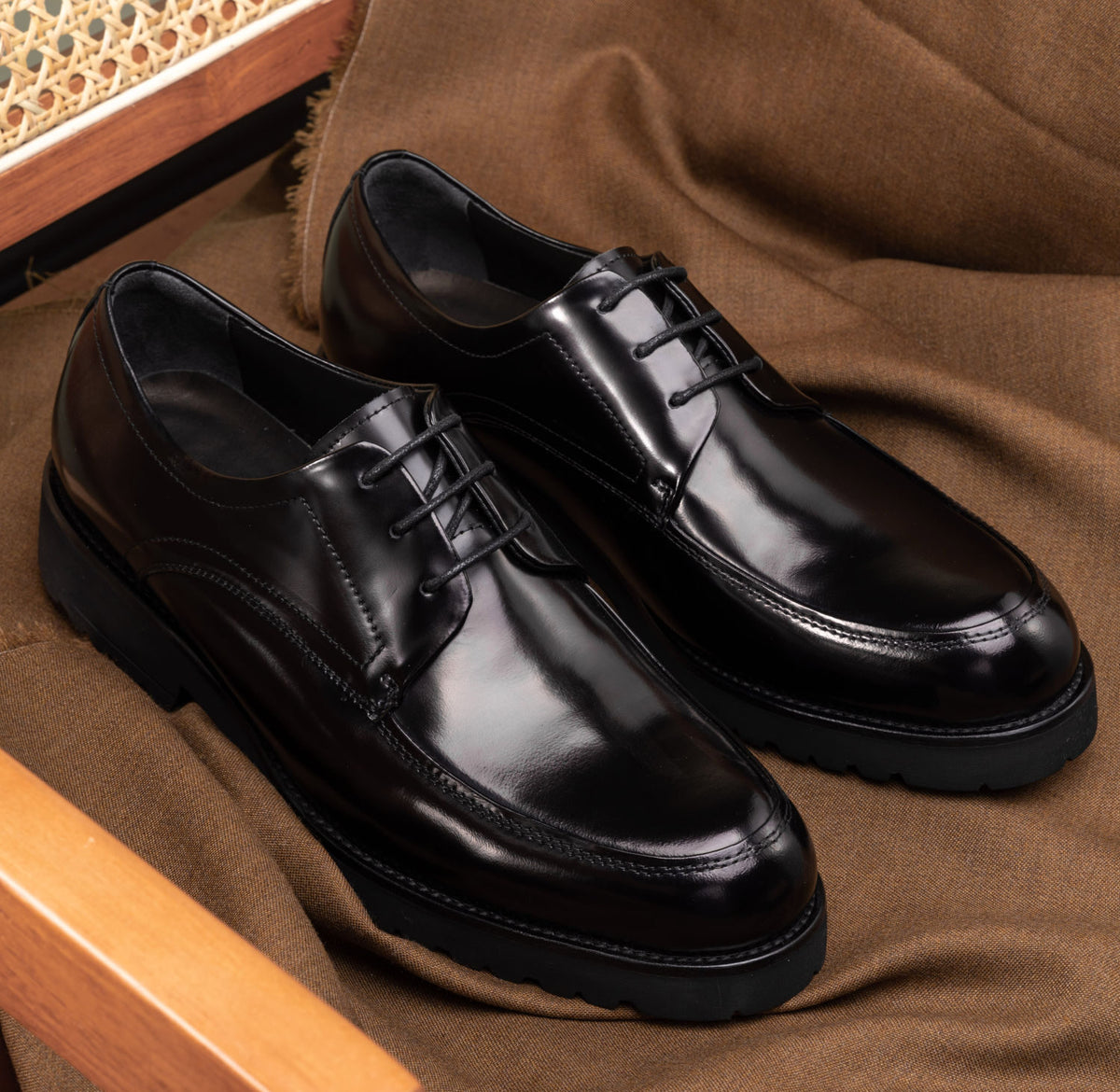 The Barmani Thick-Soled Business Black Derby (U-TIP) pair styled on a fabric surface, side view