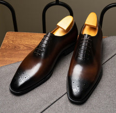 The Dino Wholecut Brogue Brown Oxfords pair with burnished patina, angled product shot