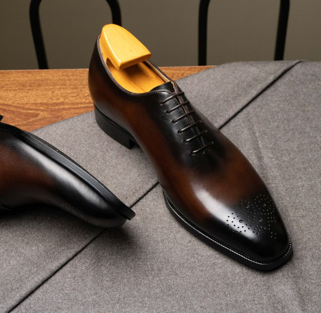Close-up of The Dino Wholecut Brogue Brown Oxfords toe cap with burnished patina finish