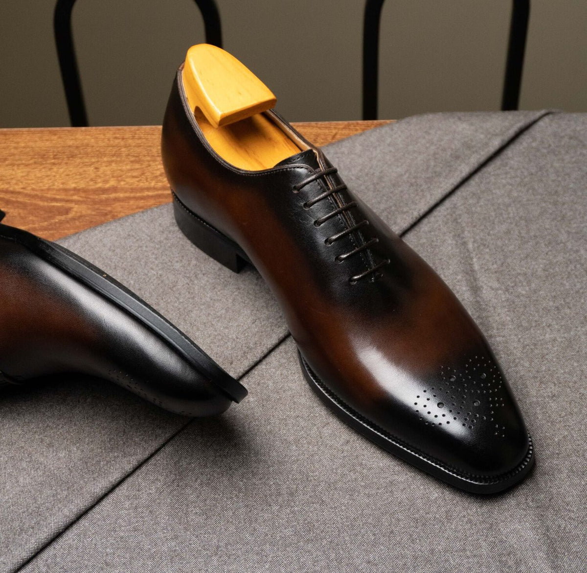Close-up of The Dino Wholecut Brogue Brown Oxfords toe cap with burnished patina finish