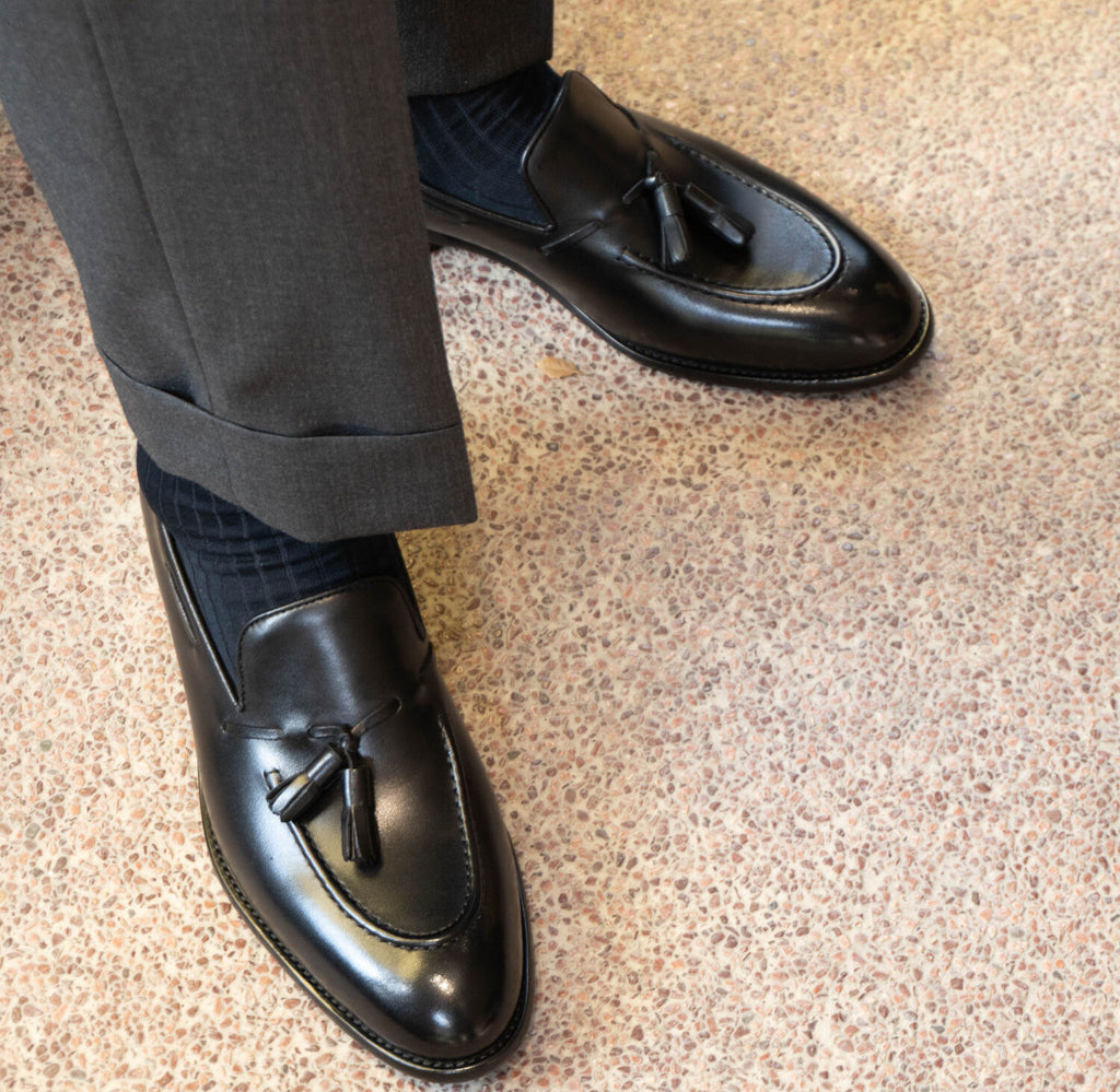 Lukas Black Leather Tassel Loafer worn on a model, standing on terrazzo flooring