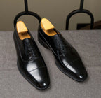 The Konbanwa Square-Toe Triple-Stitched Black Oxford pair on shoe trees, side angle