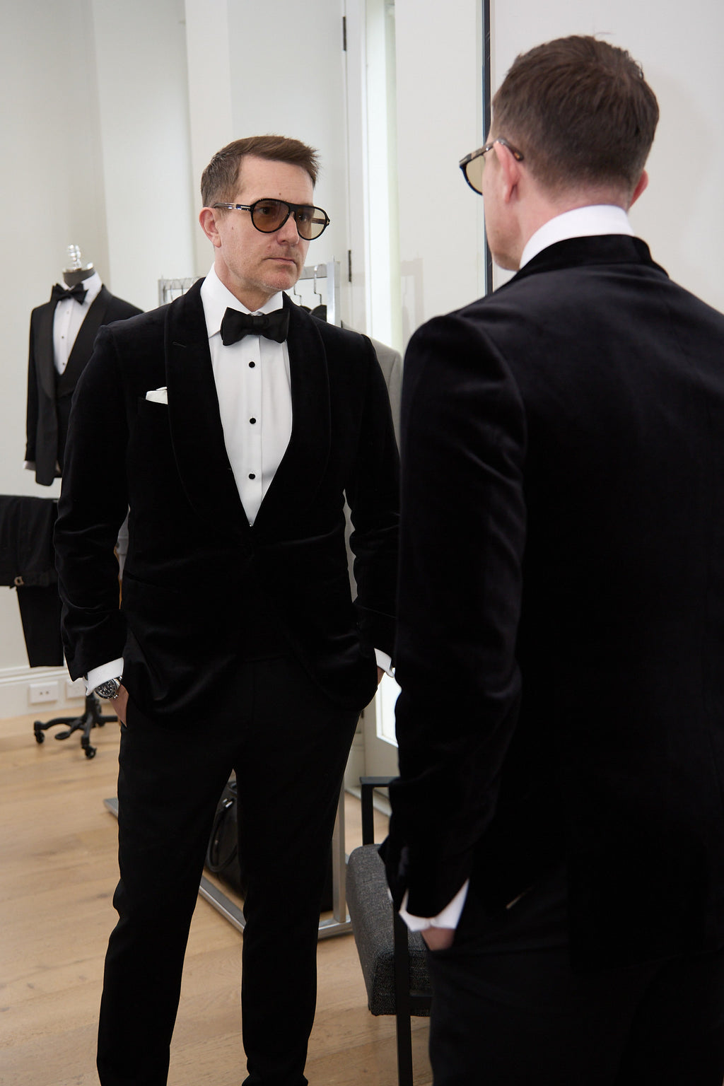 The Black Diamond Tux worn indoors, reflected beside a mirror