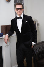 The Black Diamond Tux worn by a model beside a fireplace mantel