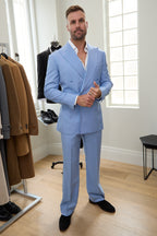 Celestial Splash sky blue suit on a model in a showroom with a clothing rack