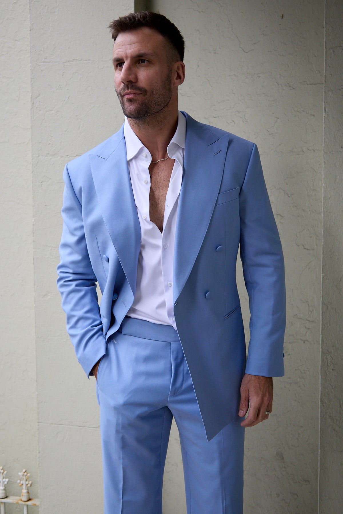 Celestial Splash sky blue suit on a model standing against an outdoor wall