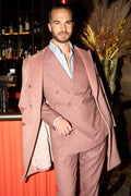 Dusty Rose Suit worn at a bar with the matching overcoat draped over one arm