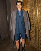 Fast Break Tailored Set with an overcoat, model with hands clasped at the same gold doorway