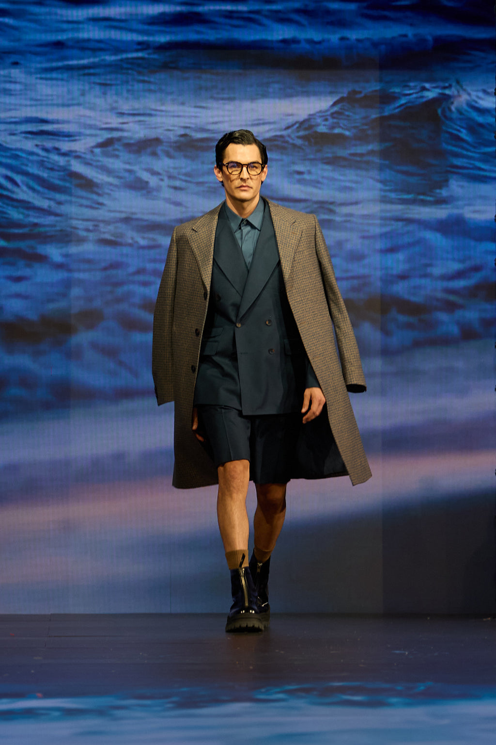 Fast Break Tailored Set on the runway, model walking with an ocean backdrop screen