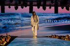 Cream Couture Suit worn full length, model walking the runway with an ocean backdrop