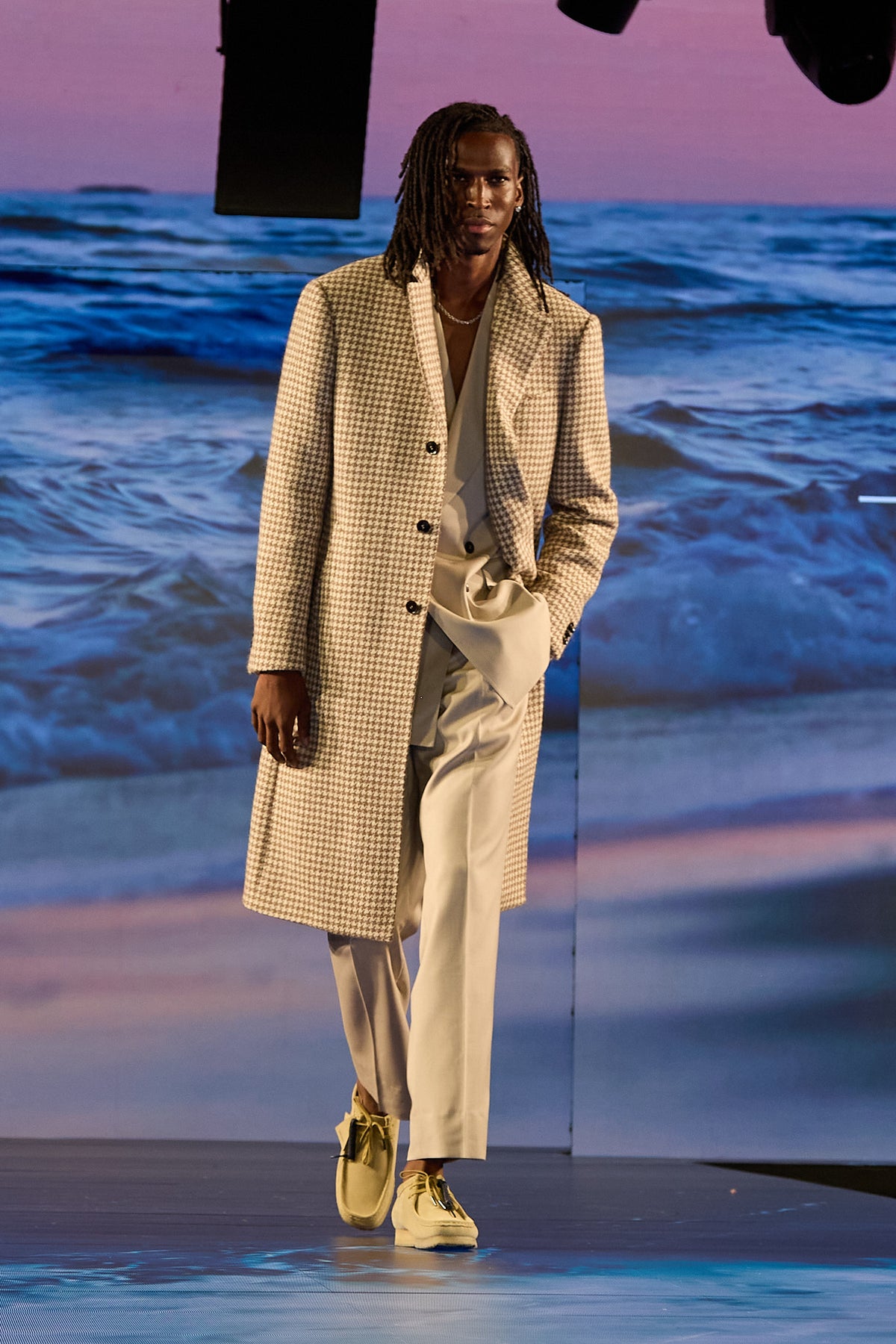 The Highland Alpaca Light Brown Overcoat on a model walking the runway, shoes visible