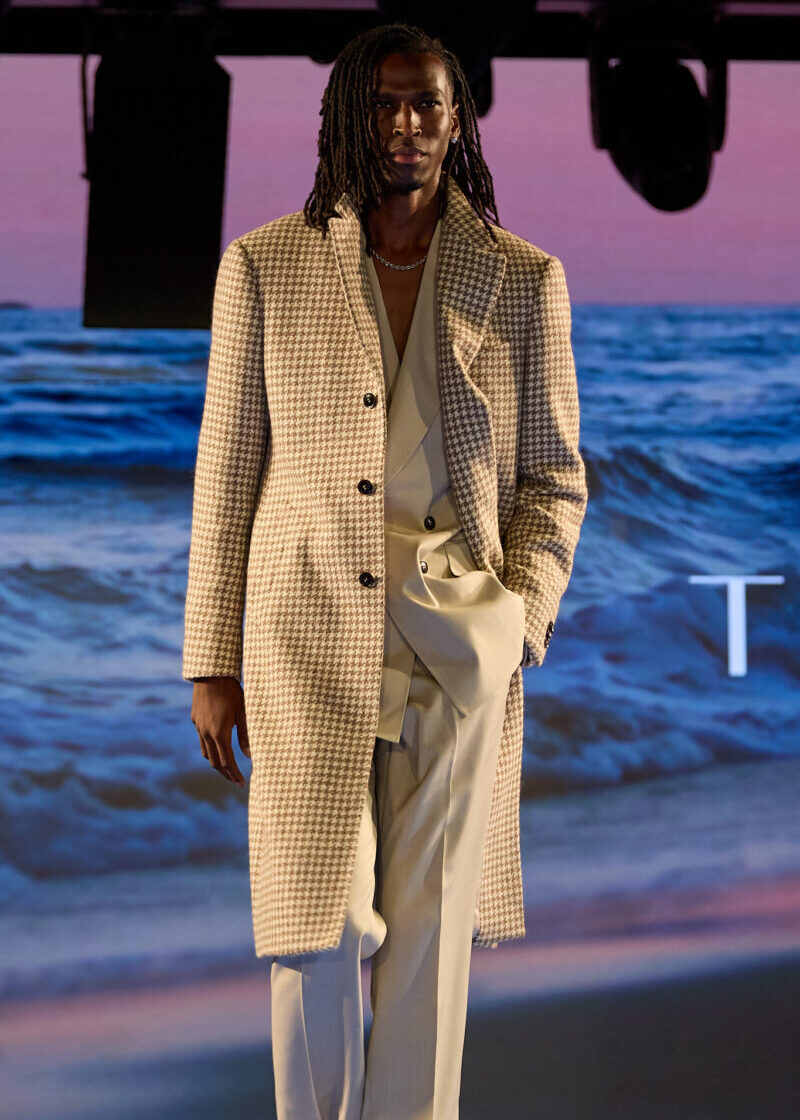 The Highland Alpaca Light Brown Overcoat buttoned on a model standing on the runway