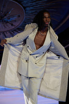Cream Couture Suit, close-up of a model holding the houndstooth blazer open on the runway