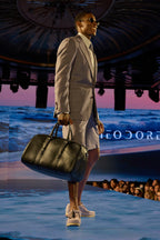 Lavender Haze Suit, side profile walking the runway smiling, ocean-themed backdrop