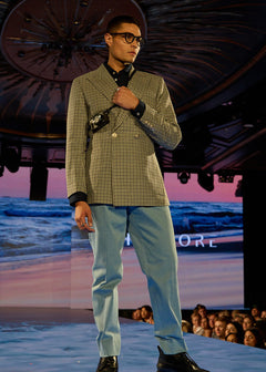 Comfort Cut Denim in pale blue, worn by a runway model with a checked blazer