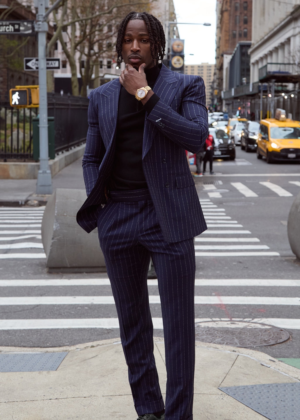 The No Filter Navy Pinstripe Suit worn full length on a model standing in a city crosswalk