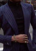 The No Filter Navy Pinstripe Suit jacket worn open over a black turtleneck, close-up on a model