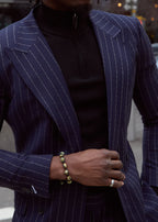 The No Filter Navy Pinstripe Suit jacket worn open over a black turtleneck, close-up on a model