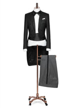 The Midnight Regent Black Tailcoat on a mannequin, full length view with striped trousers