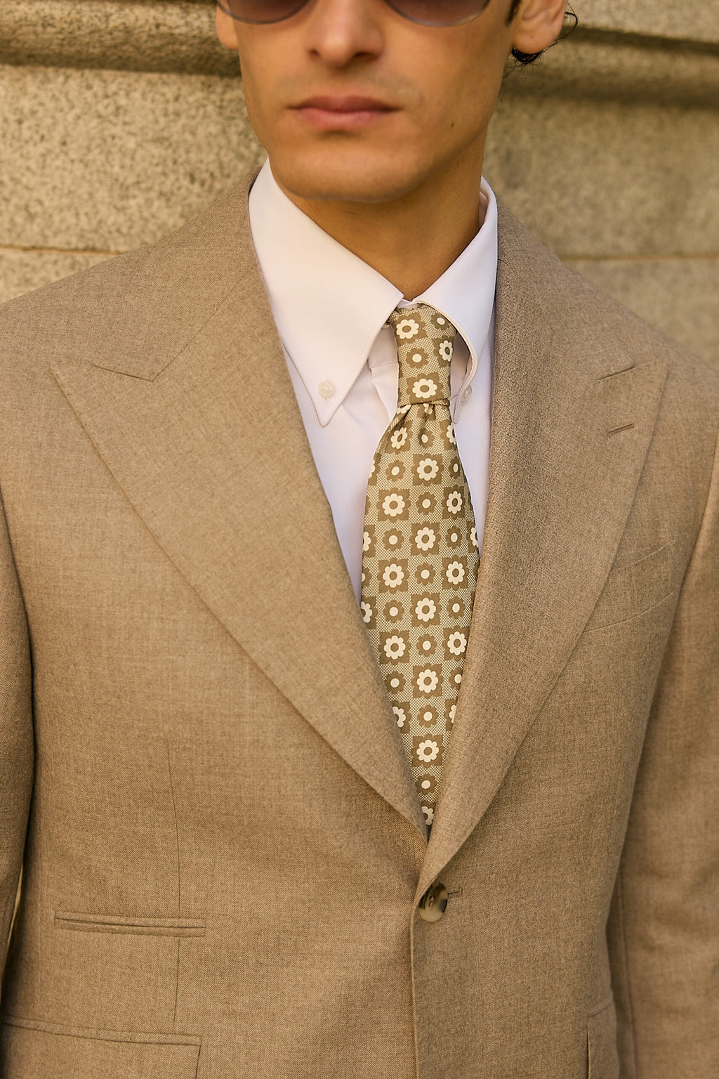 Ashford light grey suit tie and lapel close-up, model facing the camera
