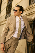 Ashford light grey suit worn open on a model leaning against a wall, full length