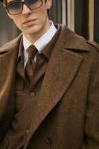 The Beaumont Brown Overcoat worn open, close-up with sunglasses and a tie beneath