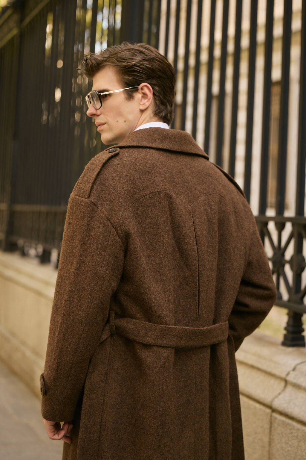 The Beaumont Brown Overcoat, back view glancing over the shoulder on a city street
