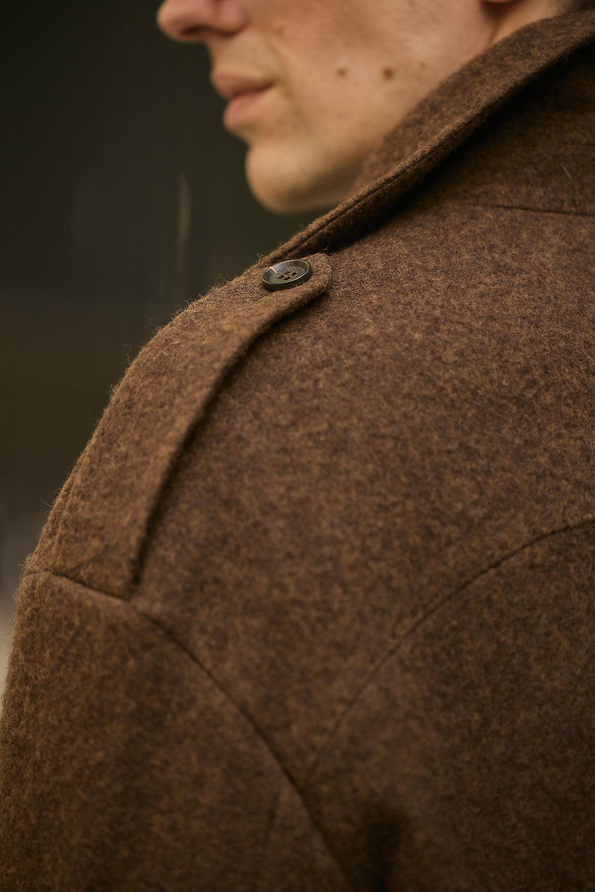 The Beaumont Brown Overcoat, macro close-up of the shoulder tab and collar button