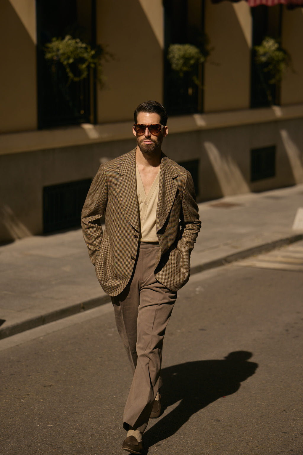The Pembroke Brown Houndstooth Casual Set worn by a model walking outdoors