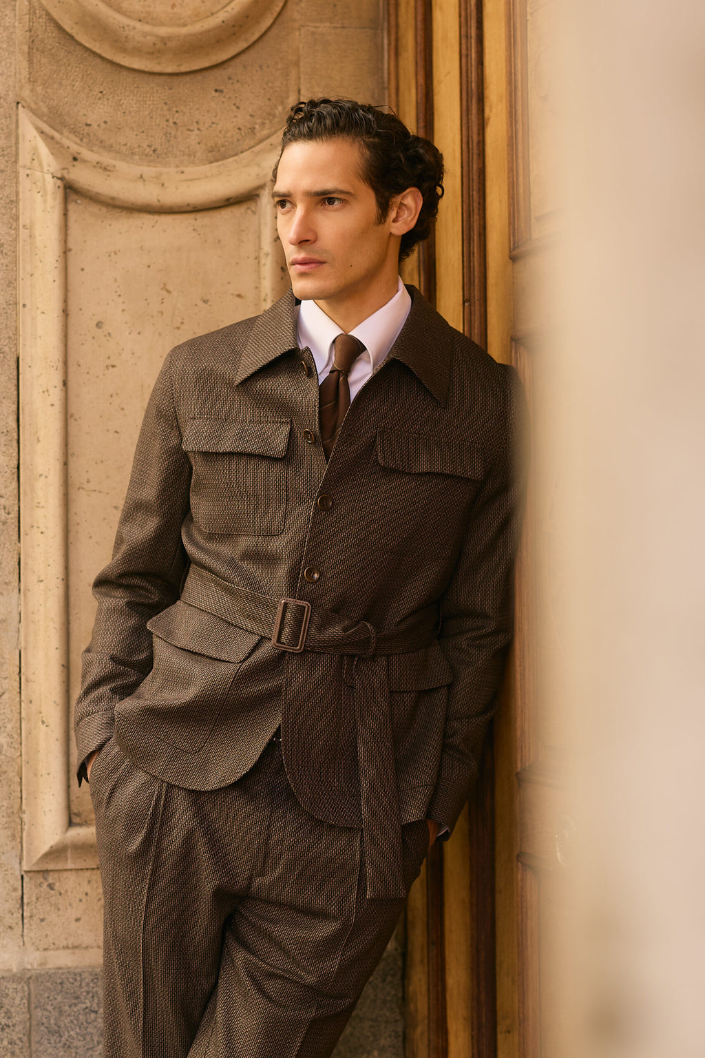 The Hawthorne Brown Jacquard Casual Set worn by a model leaning on a door
