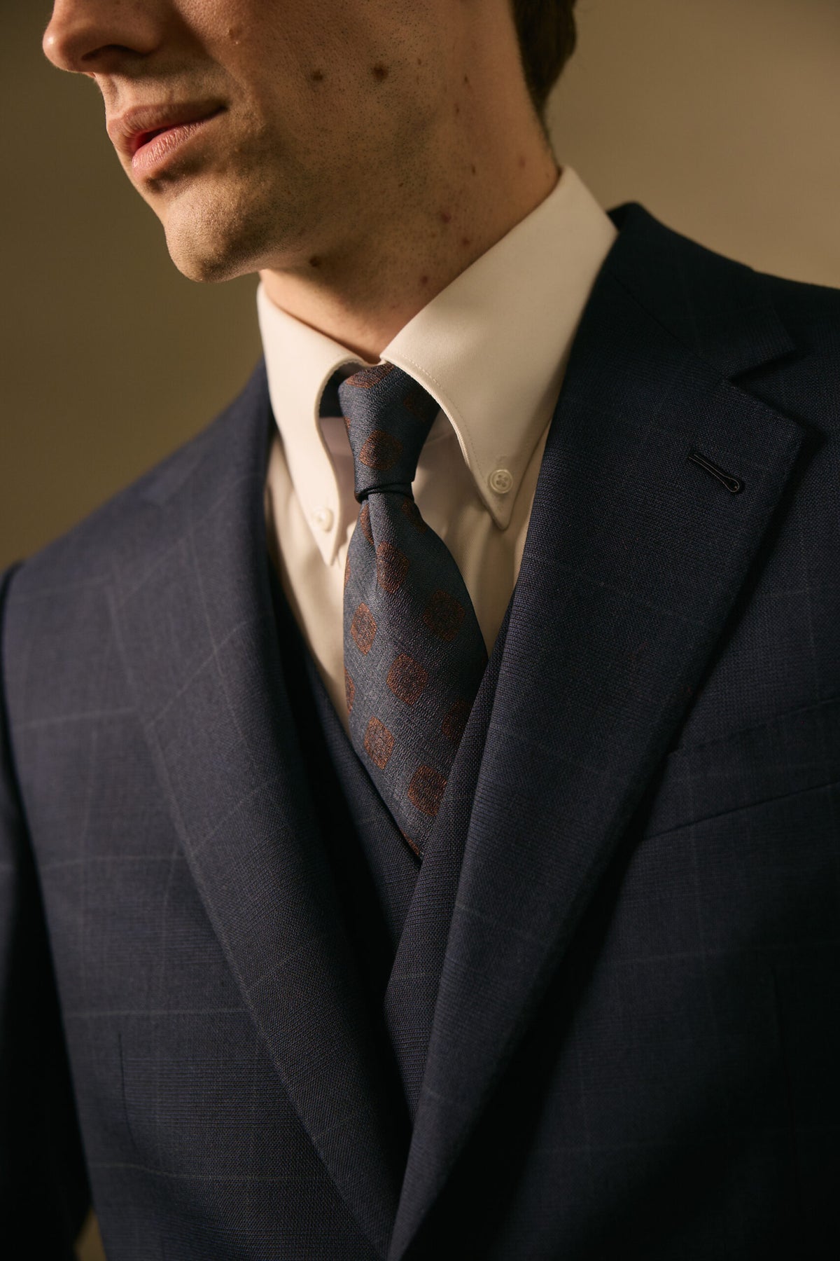 The Stratford Navy Check Suit, closer crop of the tie knot and lapel