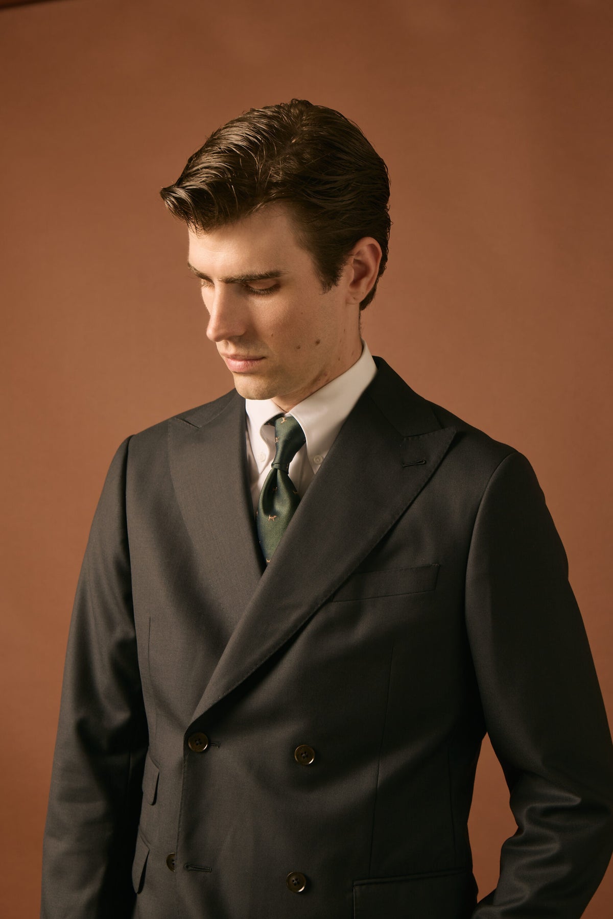 The Whitford Charcoal Suit worn by a model with a green dog-print tie