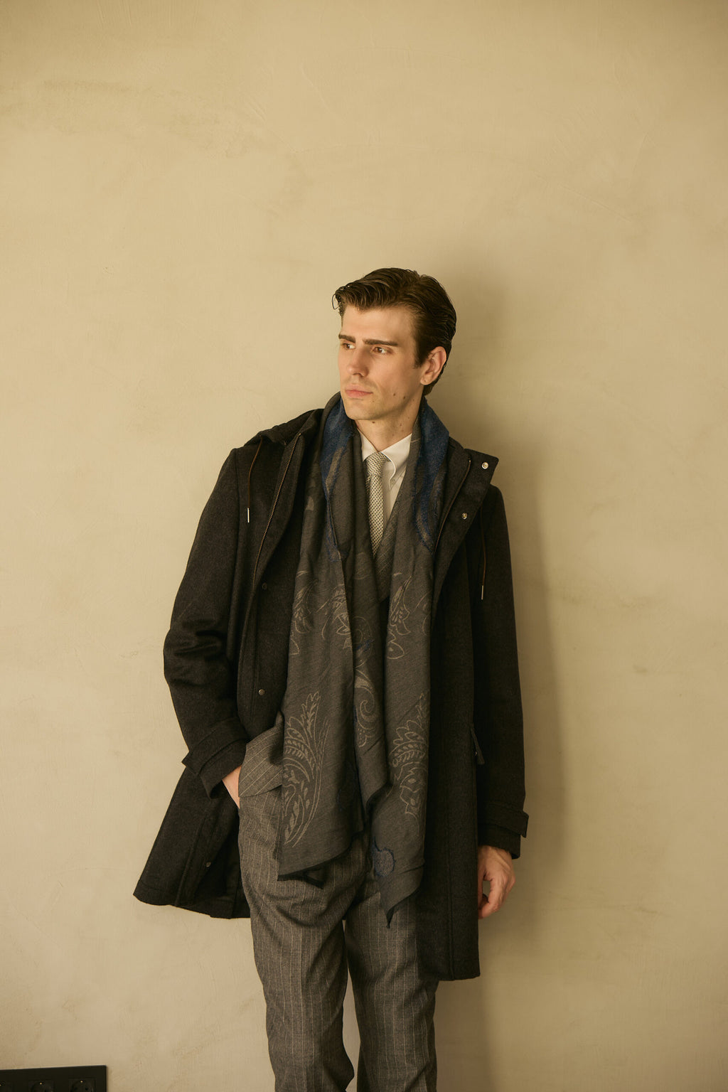 The Ashford Charcoal Overcoat, full-length shot with a patterned scarf, looking aside