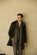 The Ashford Charcoal Overcoat, full-length shot with a patterned scarf, looking aside