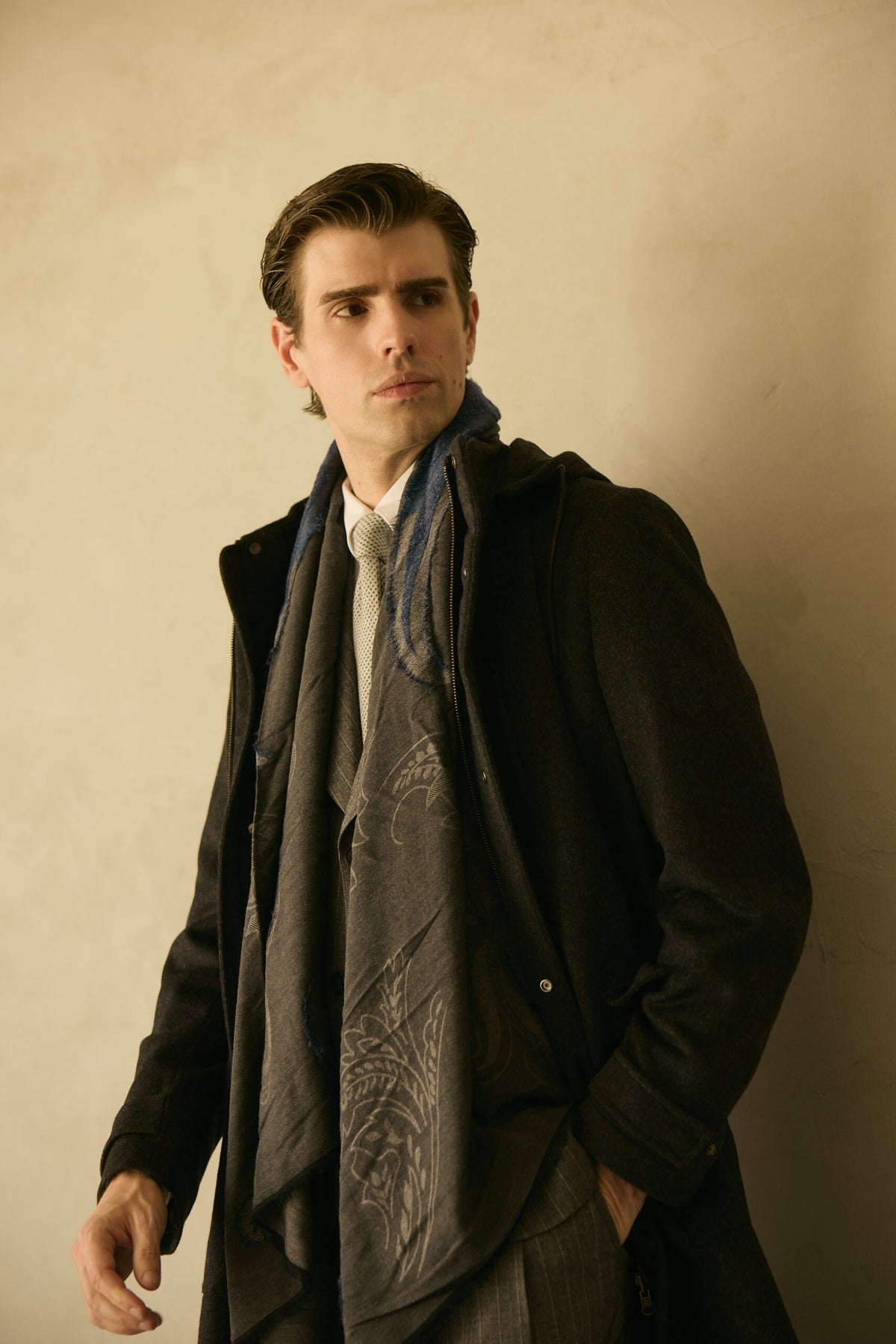 The Ashford Charcoal Overcoat, closer crop with the scarf falling open, gaze lowered