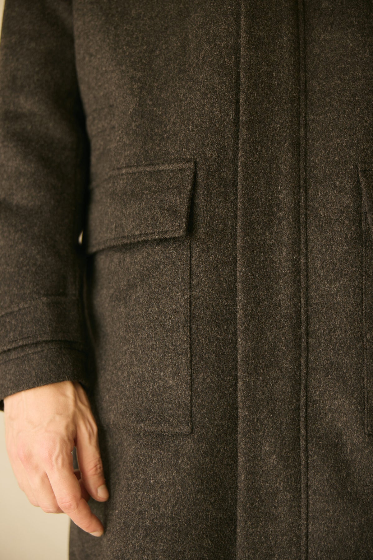 The Ashford Charcoal Overcoat, close-up of the front pocket flap and seam