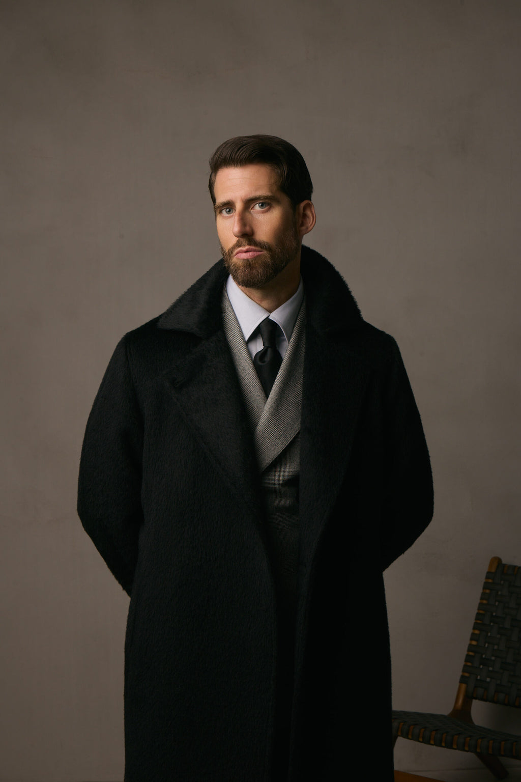 The Lancaster Black Alpaca Blend Overcoat, full-length shot with hands held behind the back