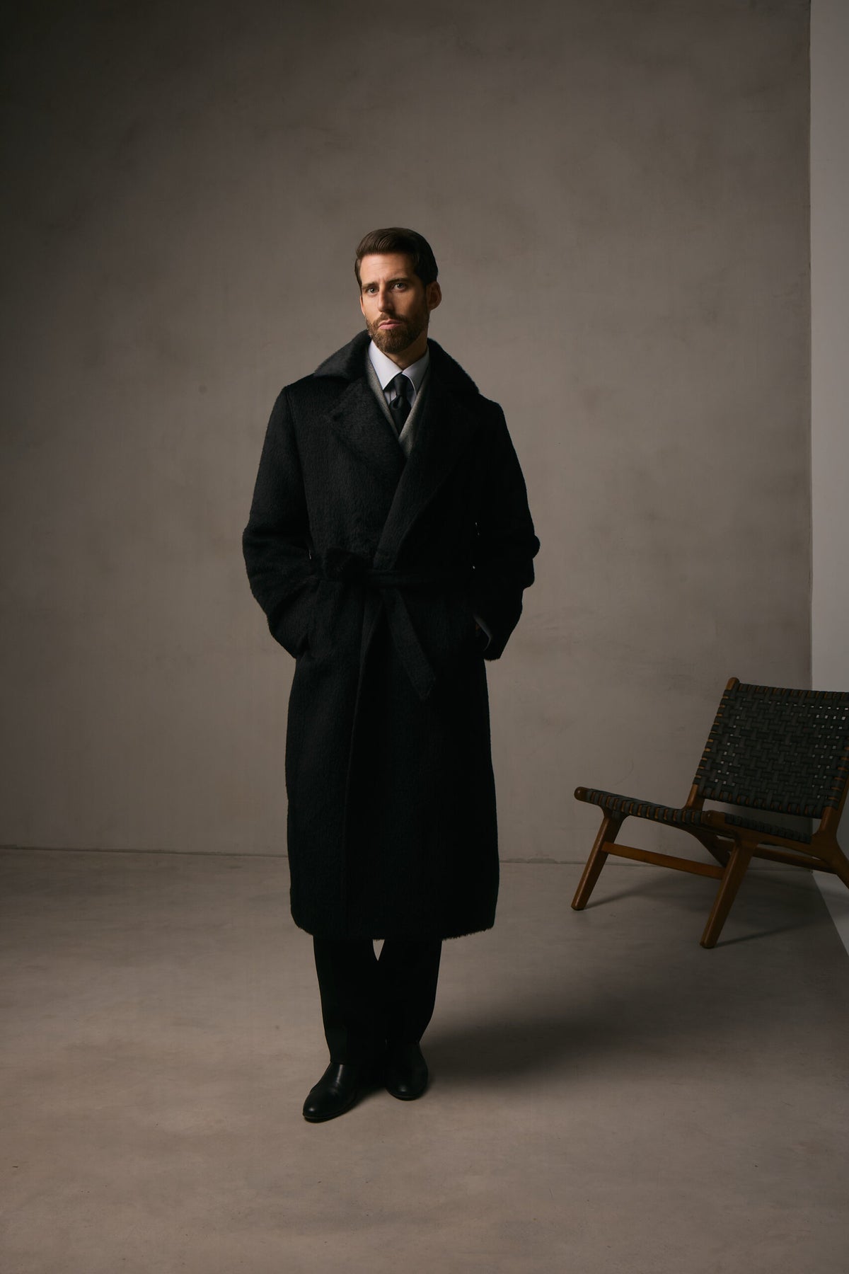 The Lancaster Black Alpaca Blend Overcoat, full-length shot in a dark studio setting