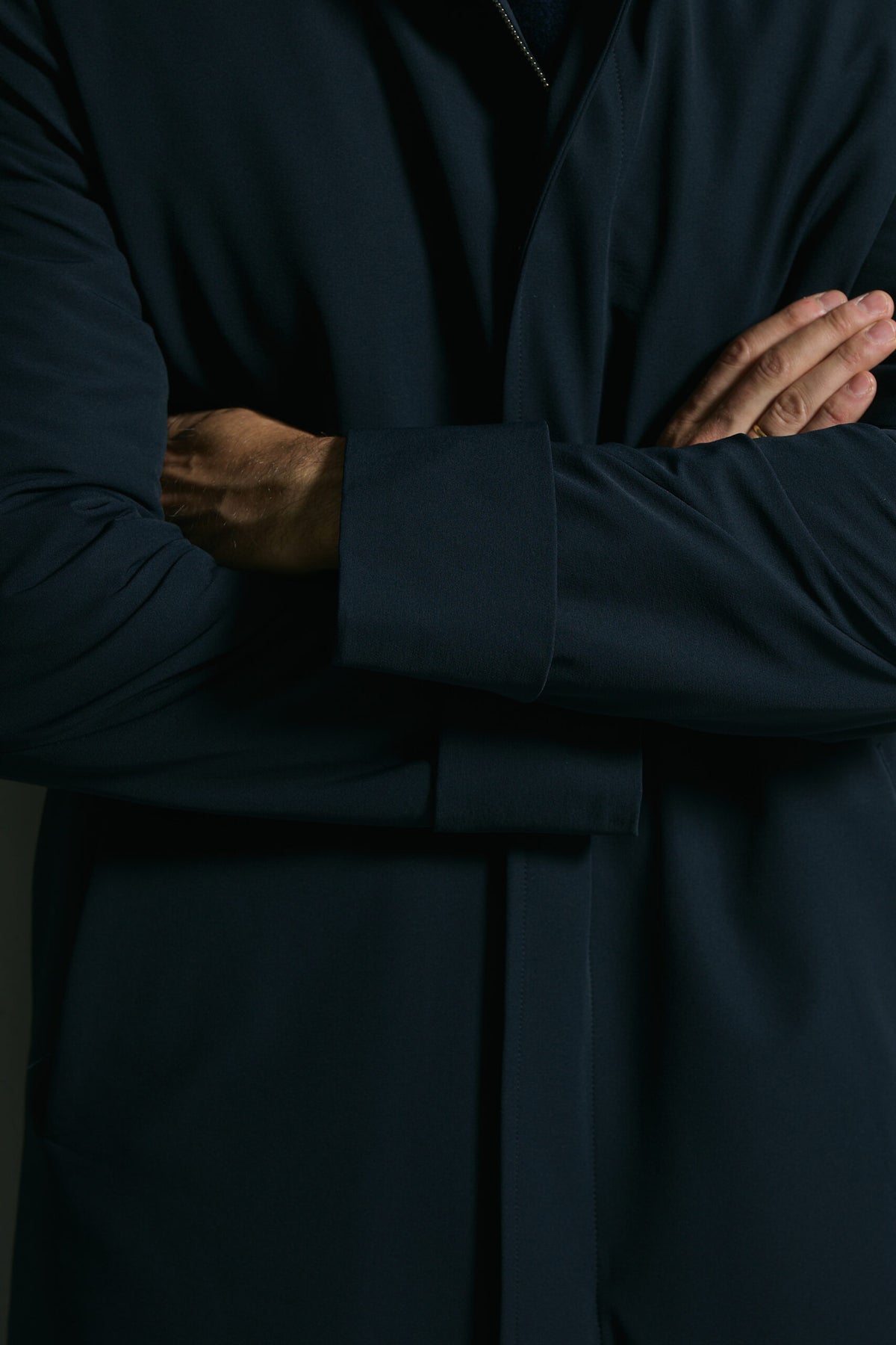 The Ellison Tech Navy Coat, close-up of the belt tie and cuff detail
