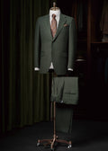 Santana Dark Green Flannel Suit displayed on a tailor's dummy with a striped tie
