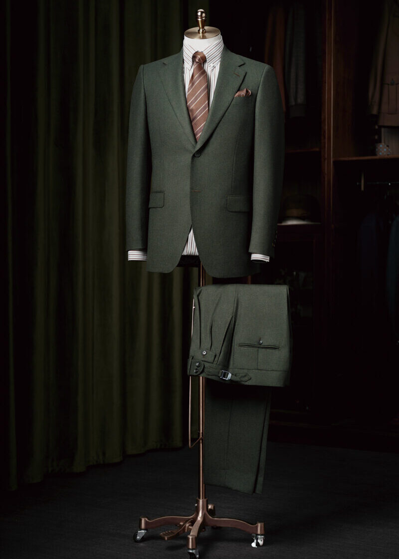 Santana Dark Green Flannel Suit displayed on a tailor's dummy with a striped tie
