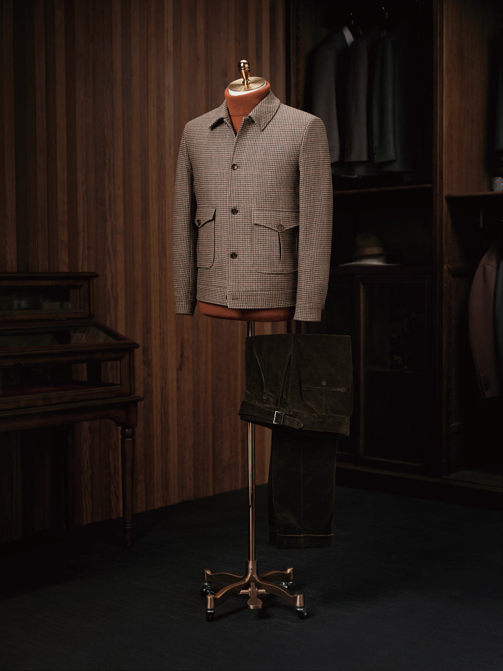 The Ginza Mocha Sports Jacket on a mannequin stand with trousers draped below, wider view