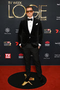 The Black Diamond Tux worn by a model on a red carpet, front view