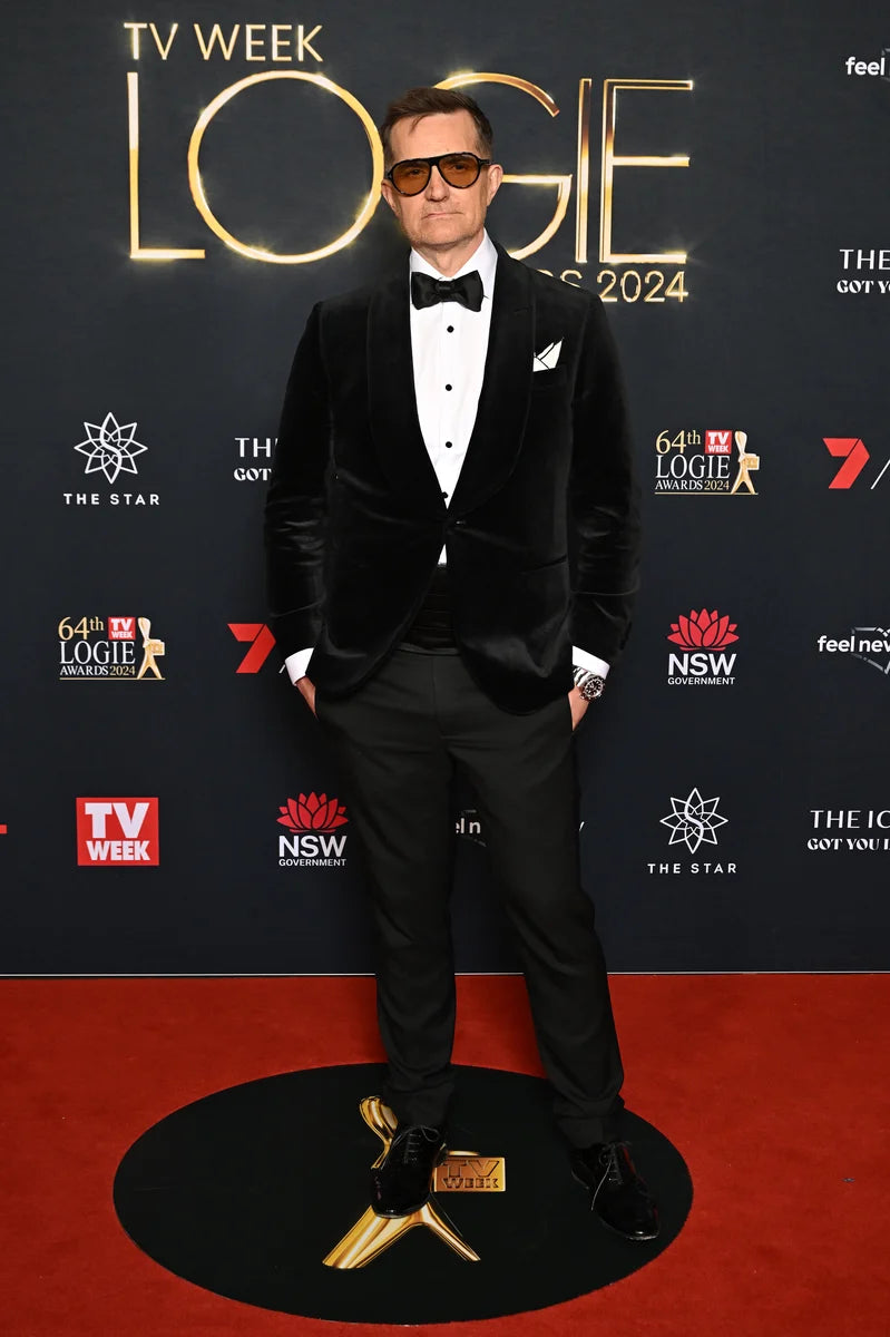 The Black Diamond Tux worn by a model on a red carpet, front view