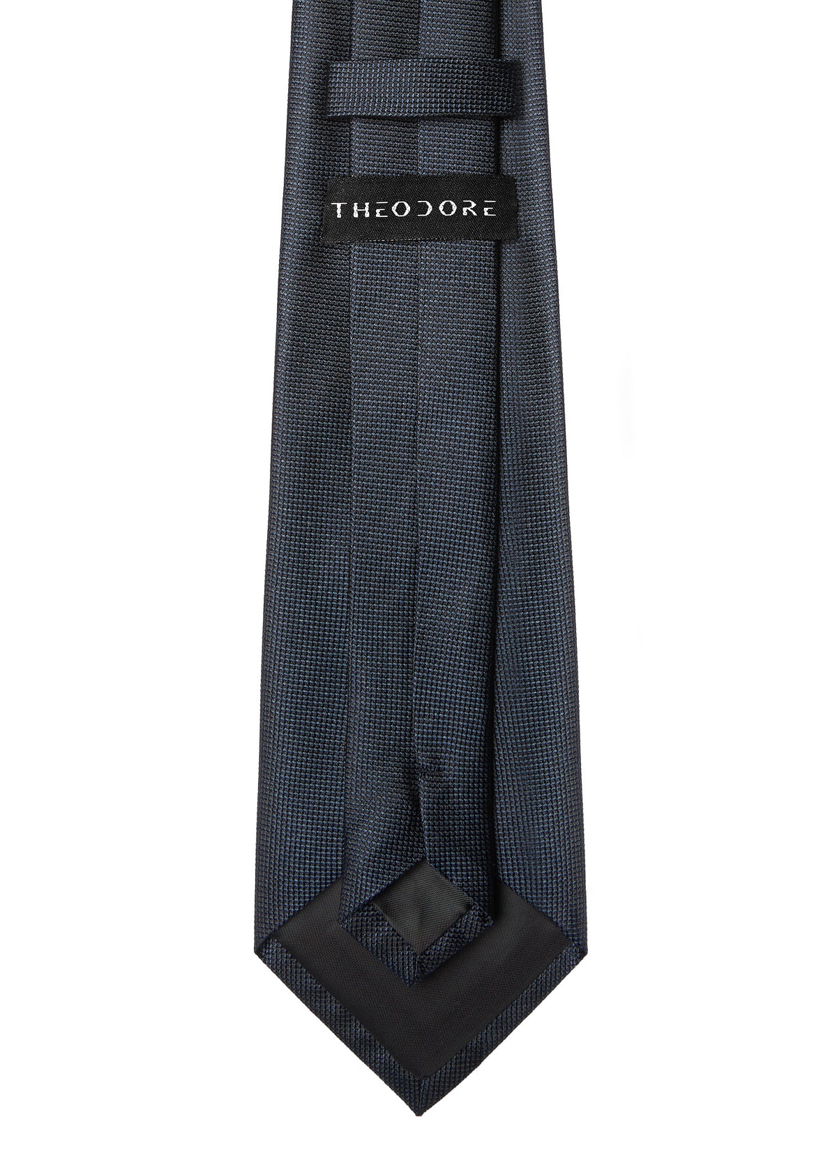 Amsterdam Silk Tie in midnight blue, angled flat lay showing the THEODORE label