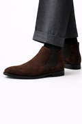 Omari Brown Suede Chelsea Boots worn on a model with cuffed grey trousers
