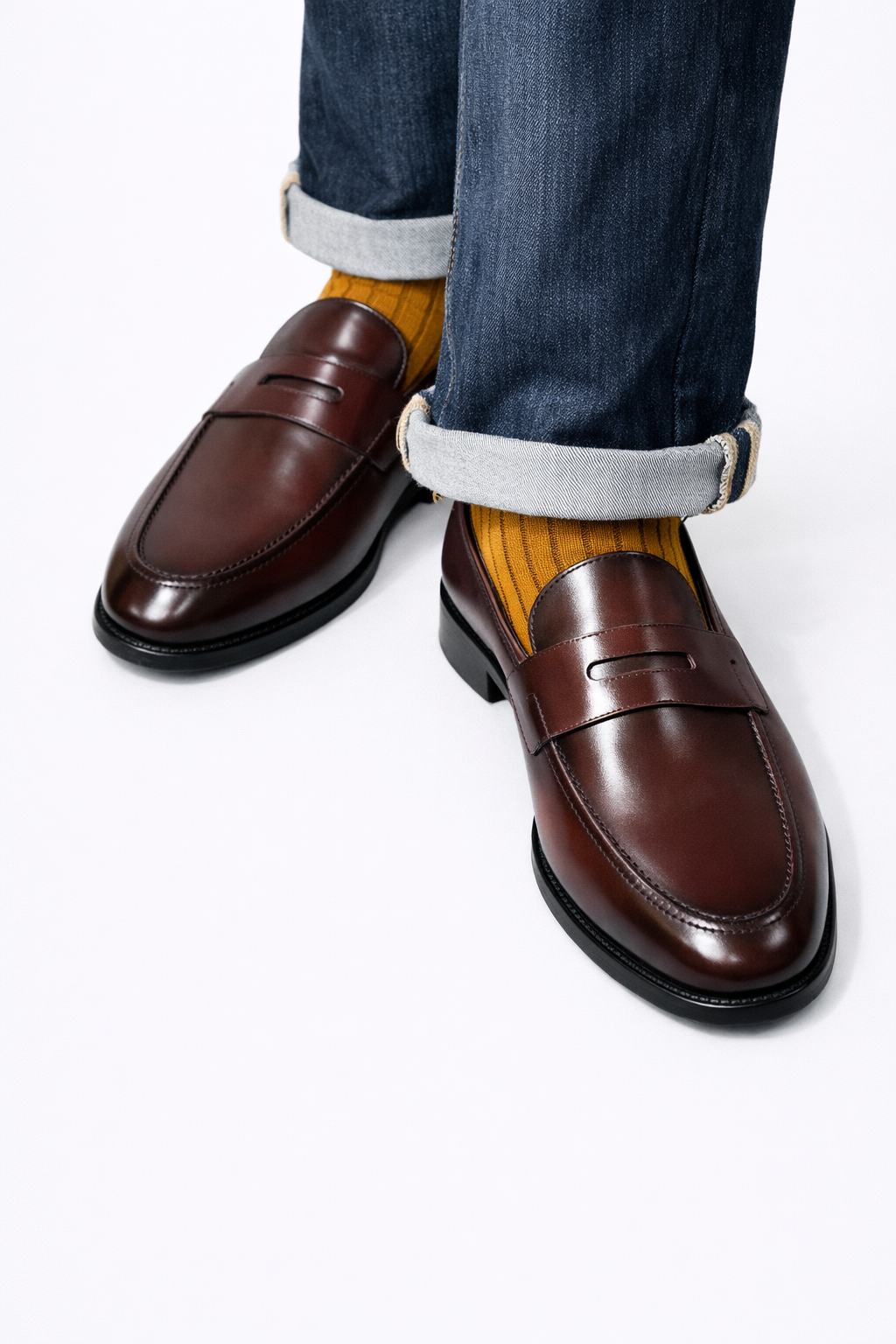 Morton Burgundy Leather Penny Loafer worn on a model with mustard socks and cuffed jeans