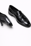 Lukas Black Leather Tassel Loafer, pair shown in a still-life on a plain background