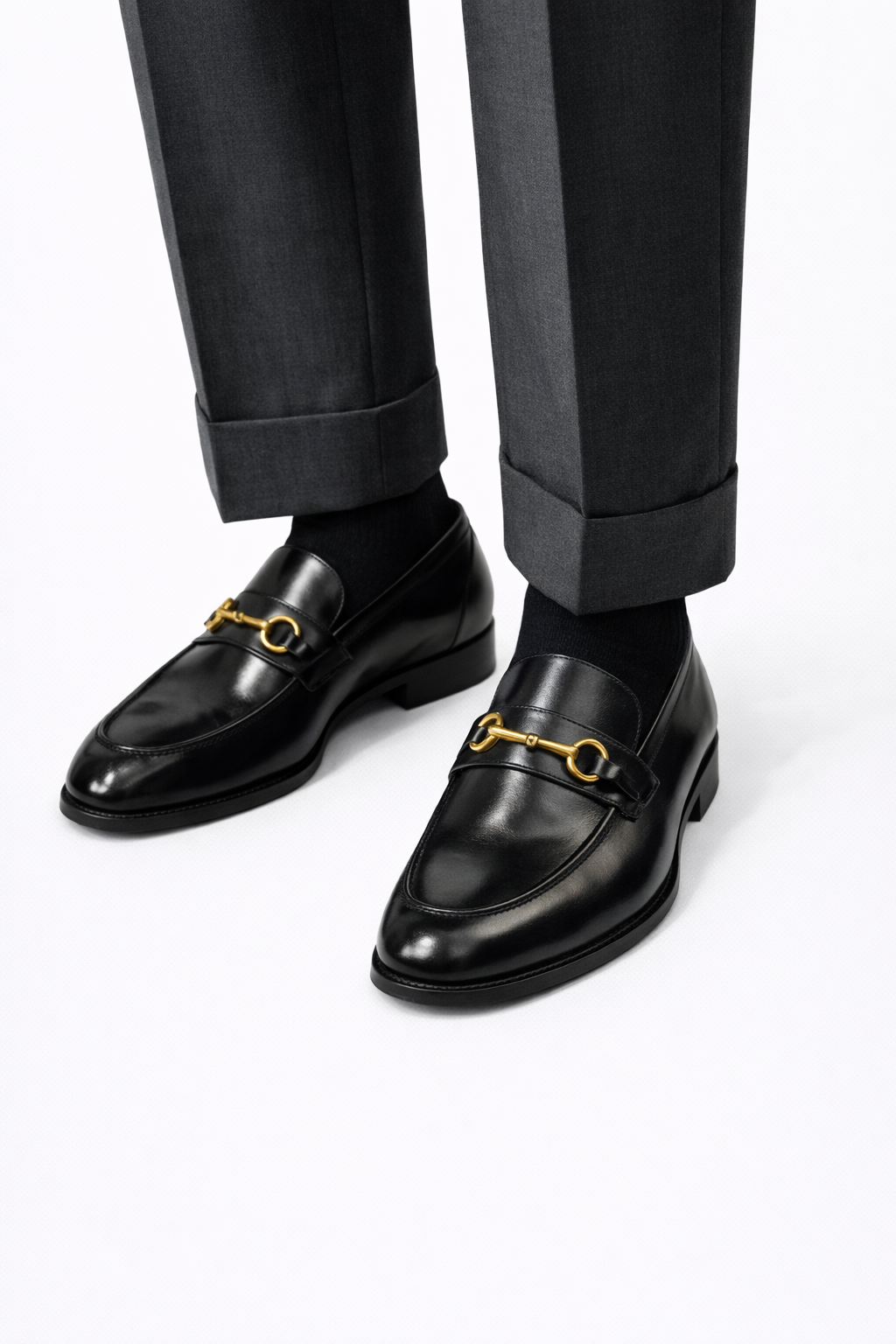 The Milson Classic Horsebit Black Loafers worn with cuffed grey trousers
