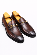 The Milson Classic Horsebit Brown Loafers on wooden shoe trees, angled three-quarter view